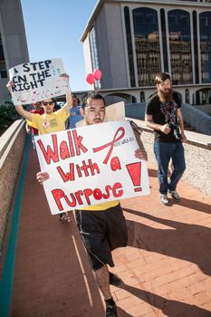TUCSON, AZ/USA - OCTOBER 12:  Unidentified walkers with signs on October 12, 2014 in Tucson, Arizona, USA.