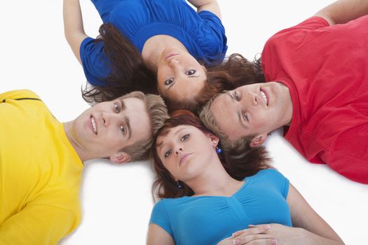 portrait of a group of young people lying on the floor, looking up- isolated on white