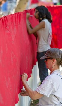 TUCSON, AZ/USA - OCTOBER 12:  Unidentified people writing on memorial AIDS ribbon on October 12, 2014 in Tucson, Arizona, USA.