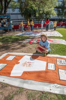 TUCSON, AZ/USA - OCTOBER 12:  Unidentifed boy with section of AIDS Quilt on October 12, 2014 in Tucson, Arizona, USA.