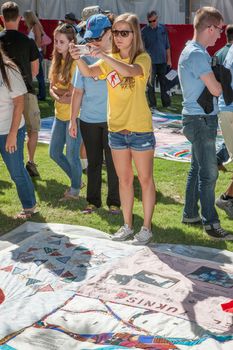 TUCSON, AZ/USA - OCTOBER 12:  Unidentifed young woman photogrph section of AIDS quilt son October 12, 2014 in Tucson, Arizona, USA.