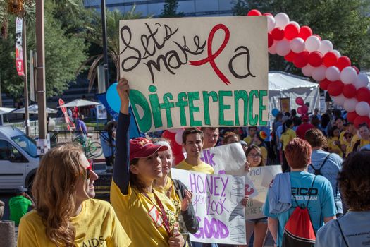 TUCSON, AZ/USA - OCTOBER 12:  Unidentified young woman encouraging AIDSwalk participants on October 12, 2014 in Tucson, Arizona, USA.