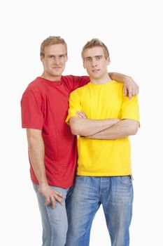 twin brothers standing looking at camera - isolated on white