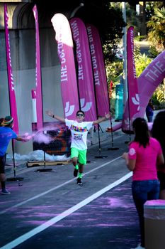 Ventura, CA - OCTOBER 18 : Participants coming through the pink color station at The Color Run 2014 in Ventura. OCTOBER 18, 2014 in Ventura, CA.