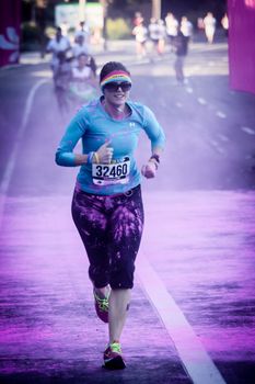 Ventura, CA - OCTOBER 18 : Participants coming through the pink color station at The Color Run 2014 in Ventura. OCTOBER 18, 2014 in Ventura, CA.