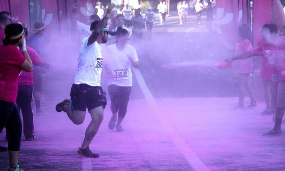 Ventura, CA - OCTOBER 18 : Participants coming through the pink color station at The Color Run 2014 in Ventura. OCTOBER 18, 2014 in Ventura, CA.