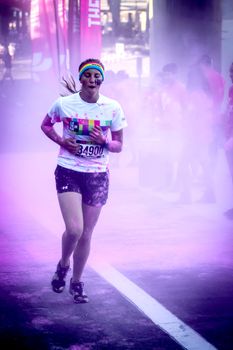 Ventura, CA - OCTOBER 18 : Participants coming through the pink color station at The Color Run 2014 in Ventura. OCTOBER 18, 2014 in Ventura, CA.