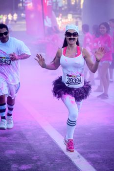 Ventura, CA - OCTOBER 18 : Participants coming through the pink color station at The Color Run 2014 in Ventura. OCTOBER 18, 2014 in Ventura, CA.