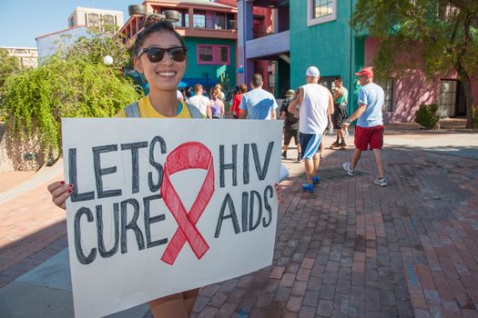 TUCSON, AZ/USA - OCTOBER 12:  Unidentified young woman encouraging AIDSwalk participants on October 12, 2014 in Tucson, Arizona, USA.