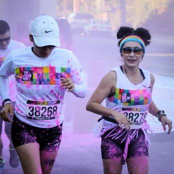 Ventura, CA - OCTOBER 18 : Participants coming through the pink color station at The Color Run 2014 in Ventura. OCTOBER 18, 2014 in Ventura, CA.