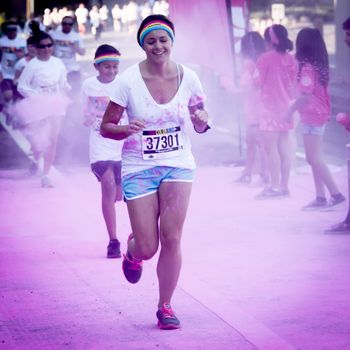 Ventura, CA - OCTOBER 18 : Participants coming through the pink color station at The Color Run 2014 in Ventura. OCTOBER 18, 2014 in Ventura, CA.