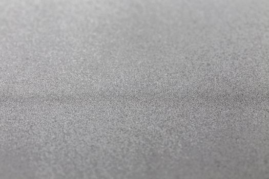 Grey silver metallic glitter shiny modern cold industrial textured background with selective focus
