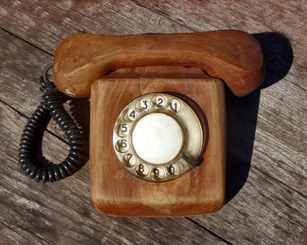 Wooden telephone on wooden background