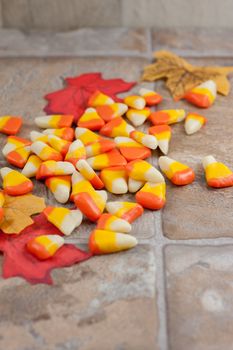 Homemade candy corn spread out accross a tile counter top.
