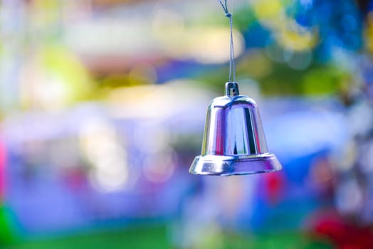 Closeup of silver bell, christmas ornament hanging on tree