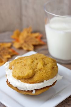 Pumpkin flavored whoopie pie cakes with whipped vanilla cream filling.