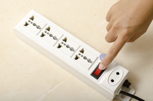 asia woman hand turn on switch multiple  socket plug electric