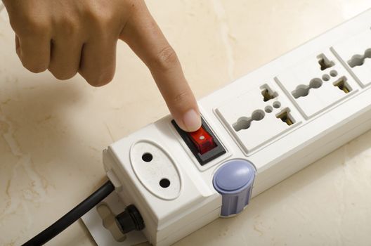 asia woman hand turn on switch multiple  socket plug electric