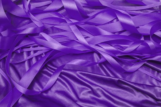 purple satin ribbons in a messy mess texture background