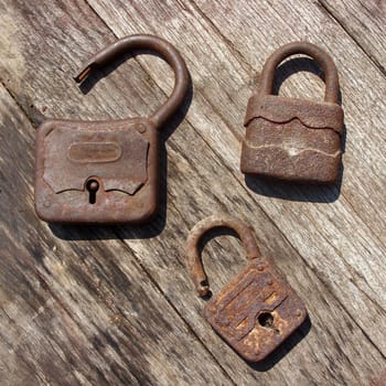 Old wooden padlocks on wooden background
