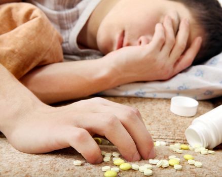 Teenager sleeps near the Pills on the Bed