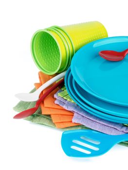 Arrangement of Multi Colored Cloth Napkins with Plastic Plates, Spoons and Cups isolated on White background