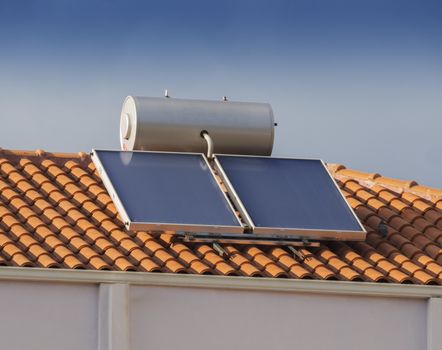 Contemporary hot water solar panels on a house roof
