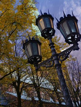 Old street light beside catholic church in riga