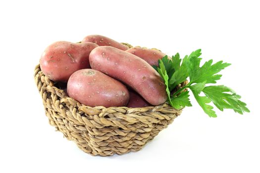 raw, red potatoes on a white background