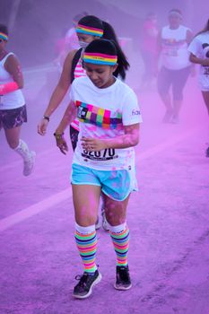 Ventura, CA - OCTOBER 18 : Participants coming through the pink color station at The Color Run 2014 in Ventura. OCTOBER 18, 2014 in Ventura, CA.