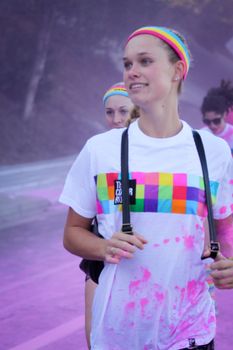 Ventura, CA - OCTOBER 18 : Participants coming through the pink color station at The Color Run 2014 in Ventura. OCTOBER 18, 2014 in Ventura, CA.