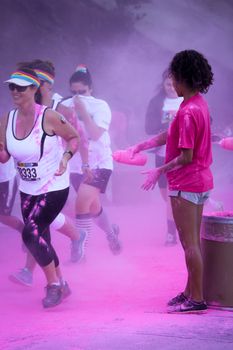 Ventura, CA - OCTOBER 18 : Participants coming through the pink color station at The Color Run 2014 in Ventura. OCTOBER 18, 2014 in Ventura, CA.