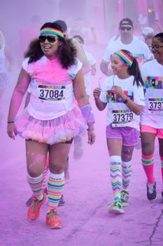 Ventura, CA - OCTOBER 18 : Participants coming through the pink color station at The Color Run 2014 in Ventura. OCTOBER 18, 2014 in Ventura, CA.