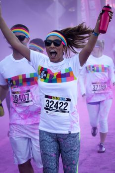 Ventura, CA - OCTOBER 18 : Participants coming through the pink color station at The Color Run 2014 in Ventura. OCTOBER 18, 2014 in Ventura, CA.