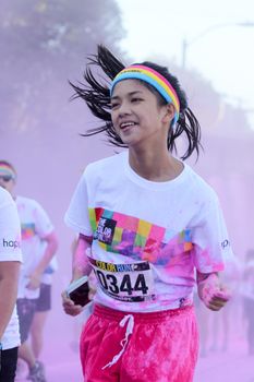 Ventura, CA - OCTOBER 18 : Participants coming through the pink color station at The Color Run 2014 in Ventura. OCTOBER 18, 2014 in Ventura, CA.