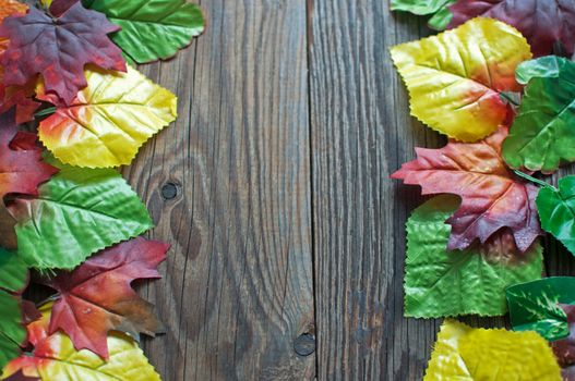 Wood background with autumn leaves frame