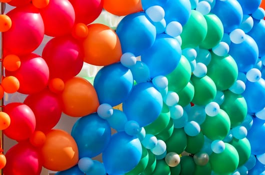 A large number of beautiful red, blue and green balloons, decoration for the holiday.