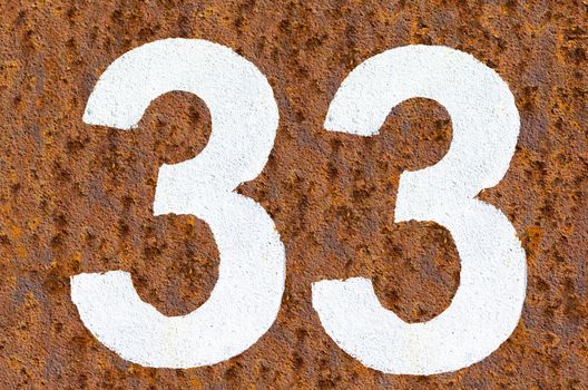 Rusty iron background with beautiful structure and number in white paint.
