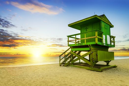 Miami South Beach sunrise with lifeguard tower and coastline with colorful cloud and blue sky. 