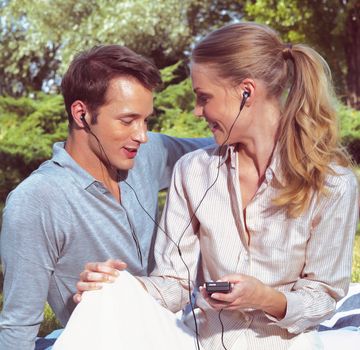 beautiful young couple listening to MP3 player 
