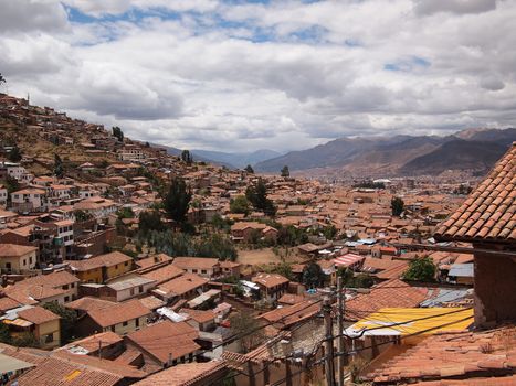 View over the orange tile roofs of the touristic city center of Cusco, near Machu Picchu, in Peru.