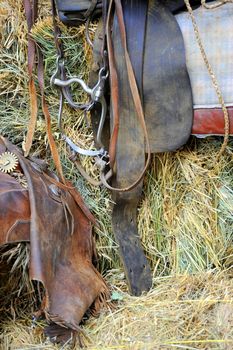 Western gear displayed inside a barn.