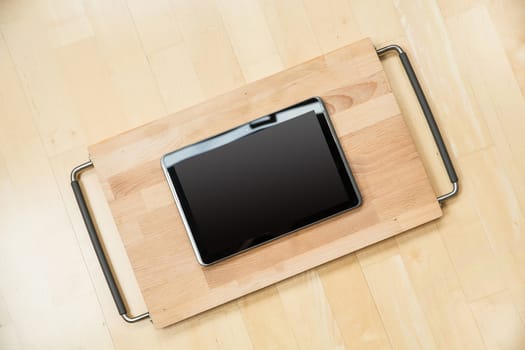 A Tablet PC on a cutting board.