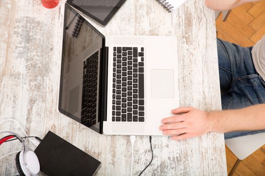 A home office with a laptop and tablet.
