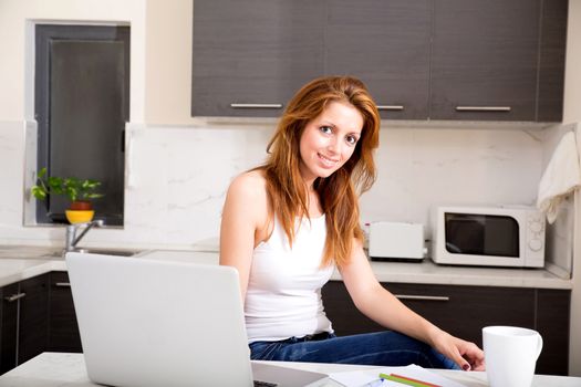 Portrait of a brunette girl working in the kitchen.