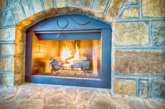 luxurious stone structure fireplace with burning fire