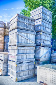 Stack of fruit boxes or crates sit outside a warehouse 