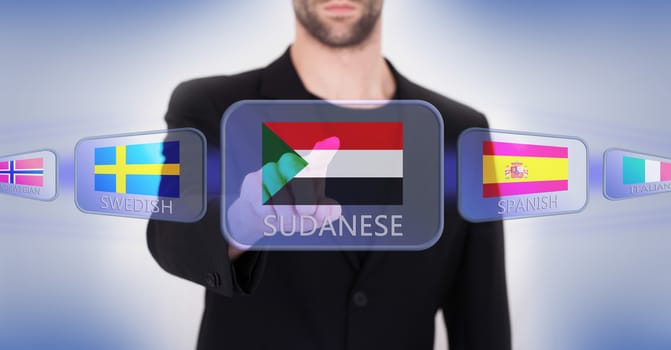 Hand pushing on a touch screen interface, choosing language or country, Sudan