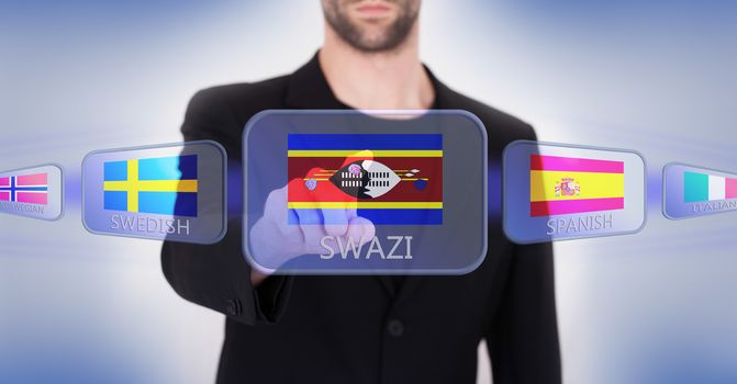 Hand pushing on a touch screen interface, choosing language or country, Swaziland