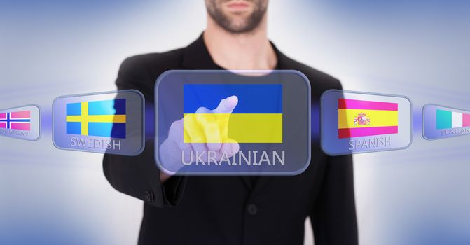 Hand pushing on a touch screen interface, choosing language or country, Ukraine